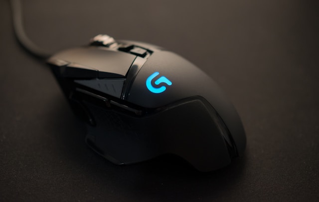 a black computer mouse with a blue light